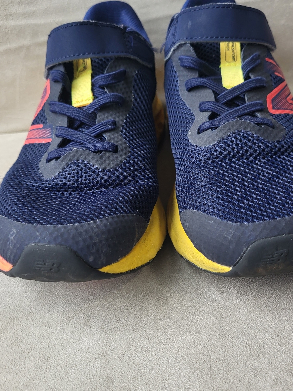 New Balance Kids Navy Blue and Yellow Sneakers with Pink Accent